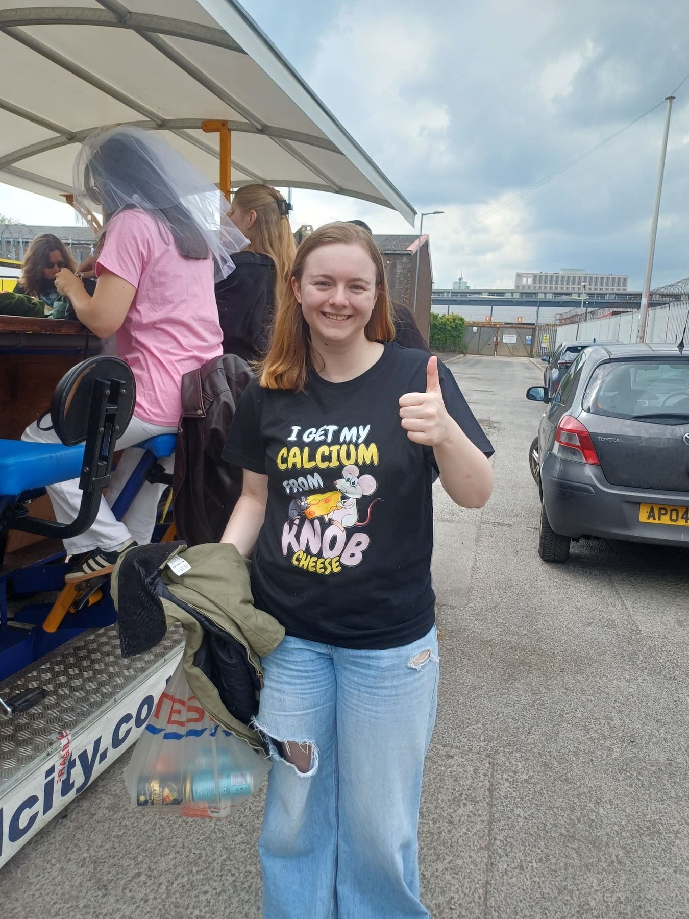 A smiling rider giving a thumbs up next to the PedalCity party bike